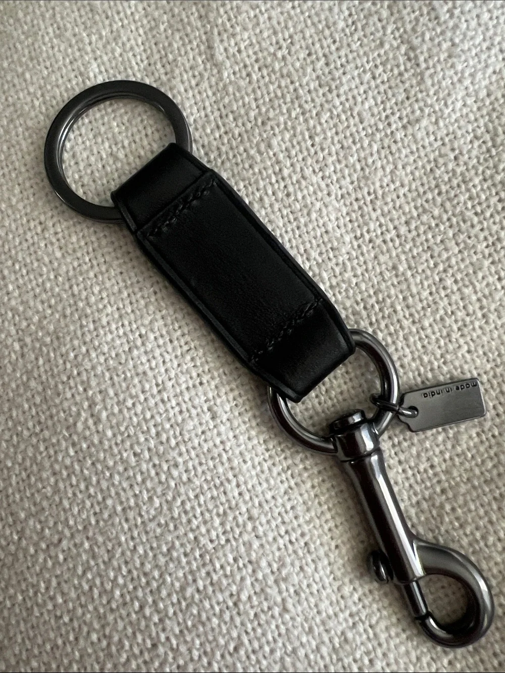 Coach Trigger Snap Key Fob black leather and silver-toned hardware.